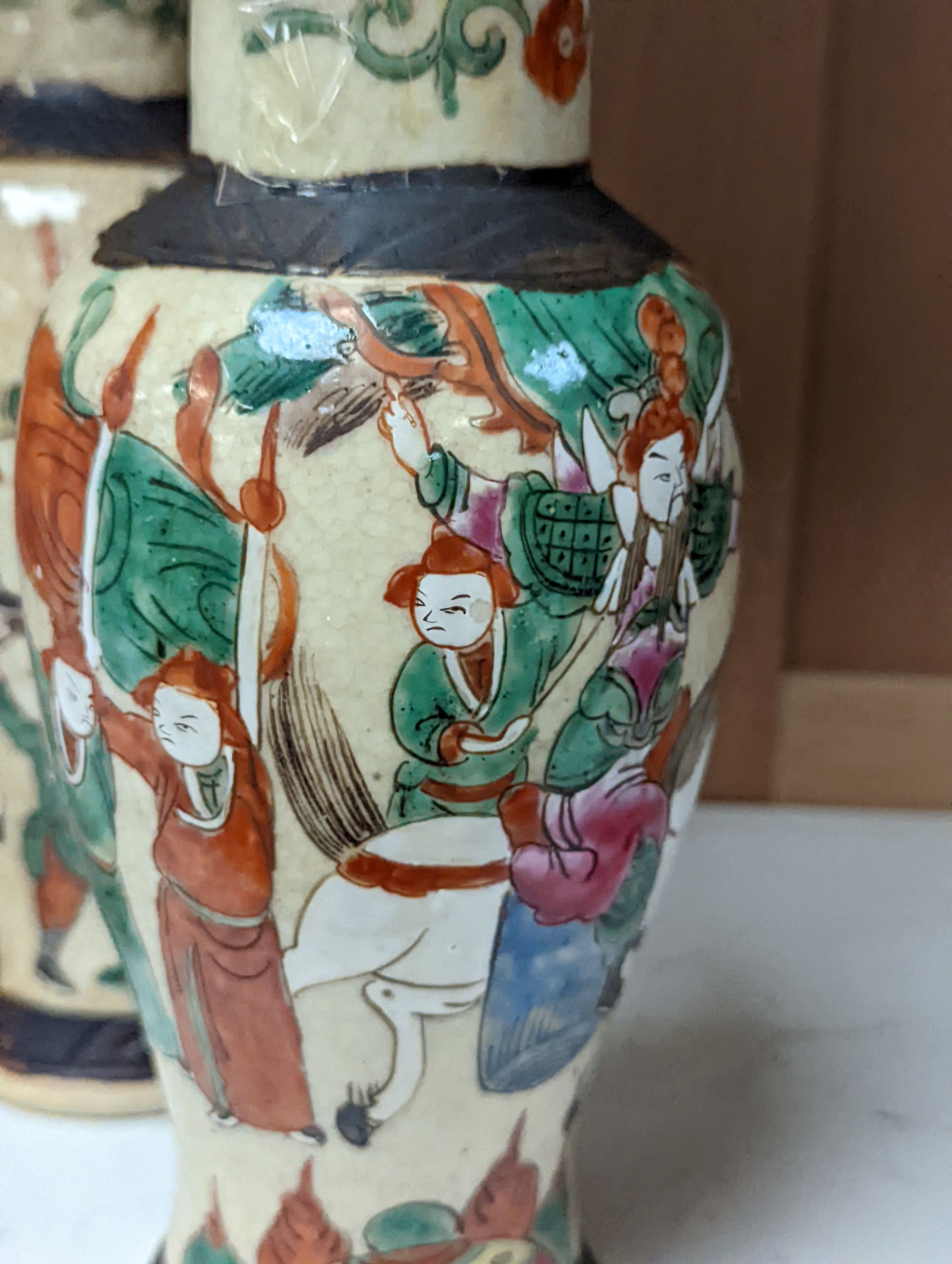 A pair of Chinese famille rose crackle glaze baluster jars and covers, 27cm.